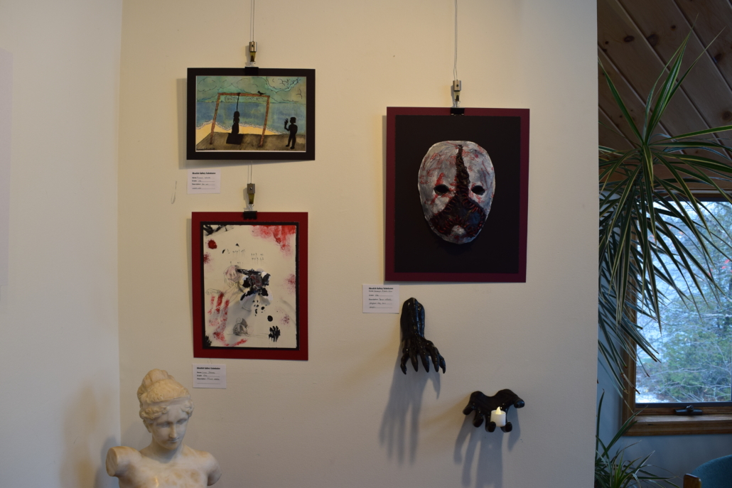Horror art hanging on a gallery wall