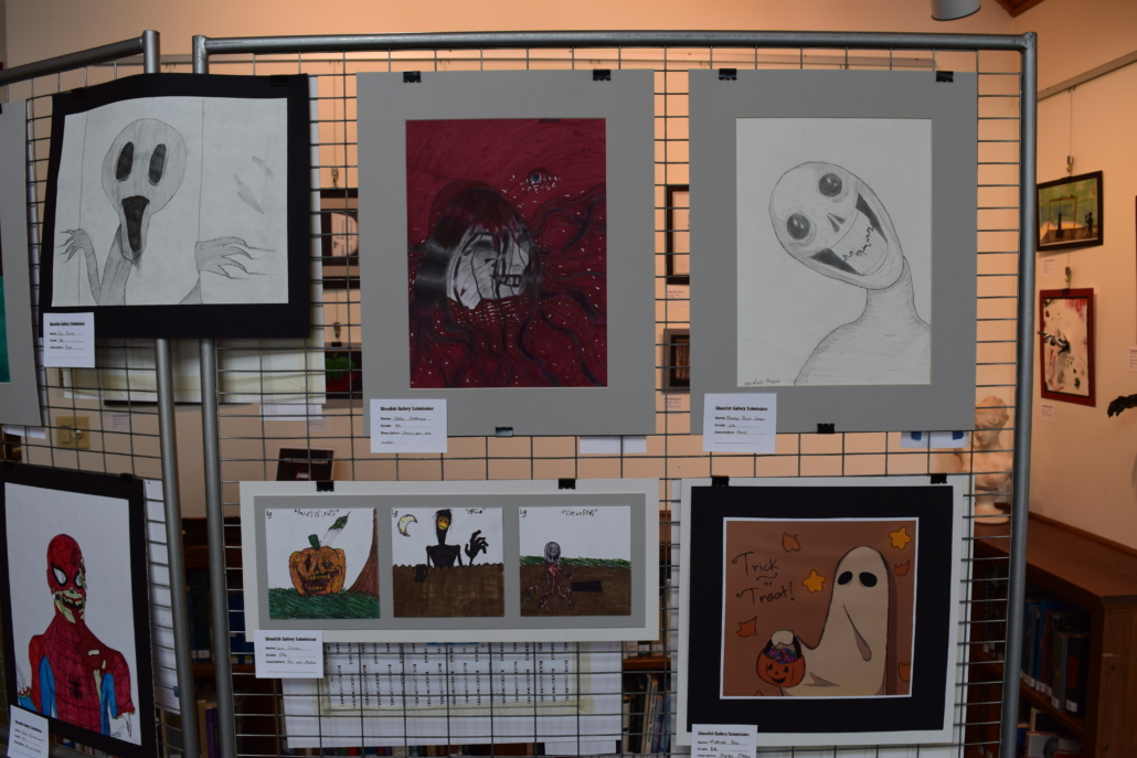 Horror art hanging on a metal stand