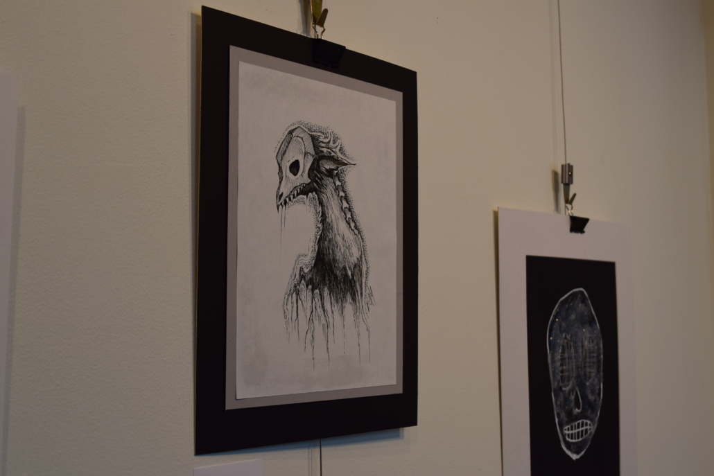 Horror art hanging on a gallery wall